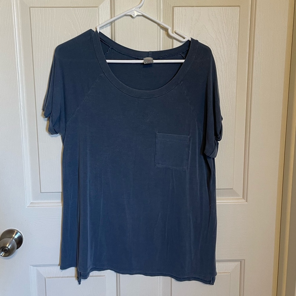 Blue/gray t shirt, front pocket, cut outs on sides goes up to just above the hip